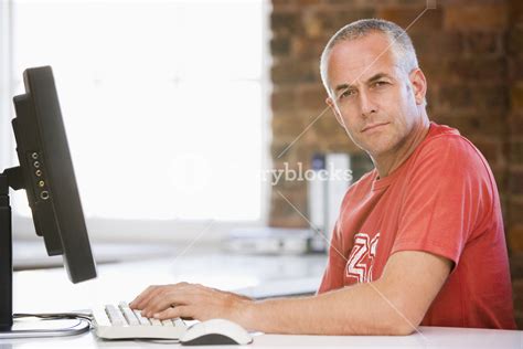 Businessman In Office Typing On Computer Royalty Free Stock Image