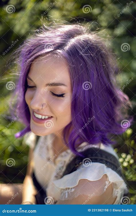 Portrait Of A Teenage Girl With Purple Hair And An Earring In Her Nose