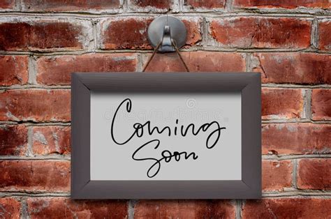 Coming Soon Handwritten Inscription In A Wooden Frame Brown Brick