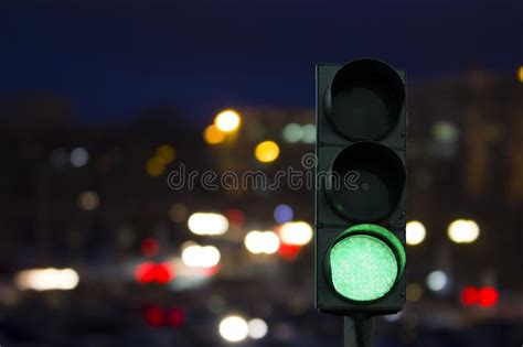 Traffic Light Green Signal On The Night On The Back Lights Of Cars