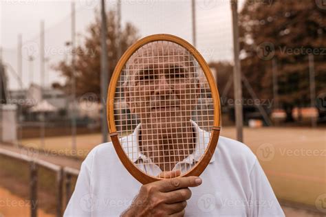 Portrait Of Senior Tennis Player Dressed In Sportswear Posing With