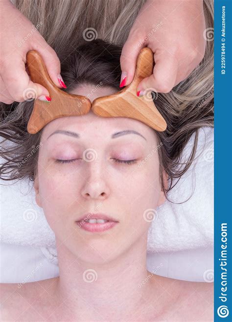 Hands Of The Masseur Massaging The Girland X27s Forehead With A Natural Wooden Massager Close Up