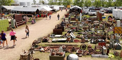 Many People Are Walking Around An Outdoor Flea Market