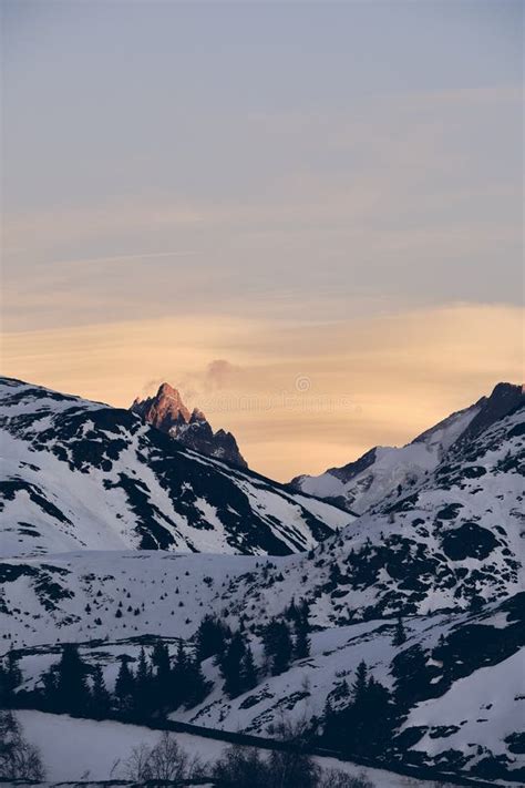 Vertical Shot Of Beautiful Snow Covered Alpine Mountain With A Colorful