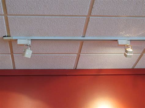 A dropped ceiling is a secondary ceiling, hung below the main (structural) ceiling. Track lighting - Wikipedia