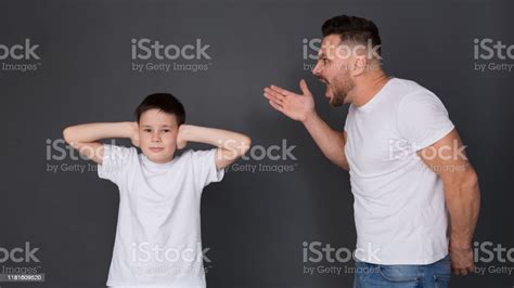 Nervous Father Screaming At Son Boy Closing Ears Stock Photo Download