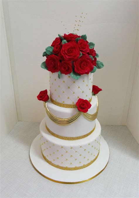 three tier white and gold wedding cake with red fondant roses white and gold wedding cake