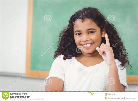 Smiling Pupil Raising Hand In A Classroom Stock Image Image Of Girl