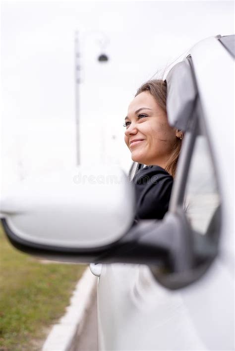 Caucasian Girl Looks Out Of The Window Of The Front Passenger Seat Of A