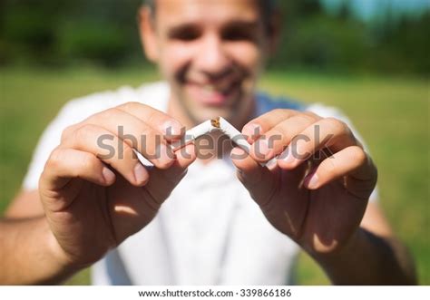 Young Man Breaking Cigarette On Green Stock Photo 339866186 Shutterstock