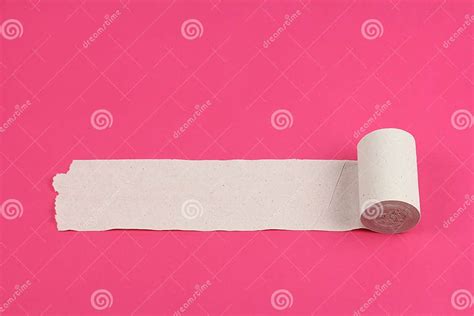 Unrolled Roll Of Rough White Toilet Paper On Pink Background Close Up