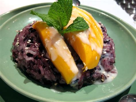 sweet purple rice topped w mango and coconut cream another delicious laotian dessert this is