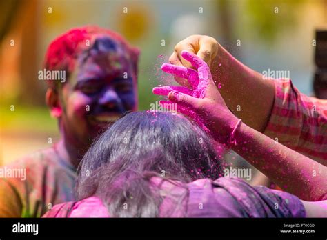 People Covered In Colorful Powder Dyes Celebrating The Holi Hindu