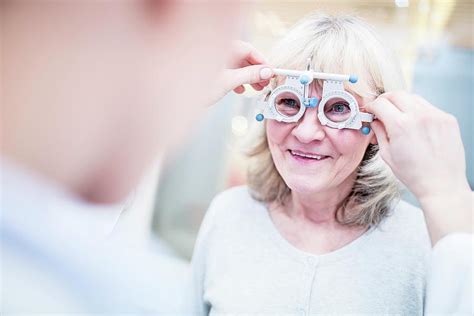 Optometrist Performing Eye Test Photograph By Science Photo Library
