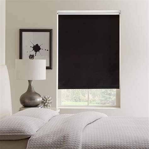 A Black Roller Shade In A Living Room With White Furniture And Artwork