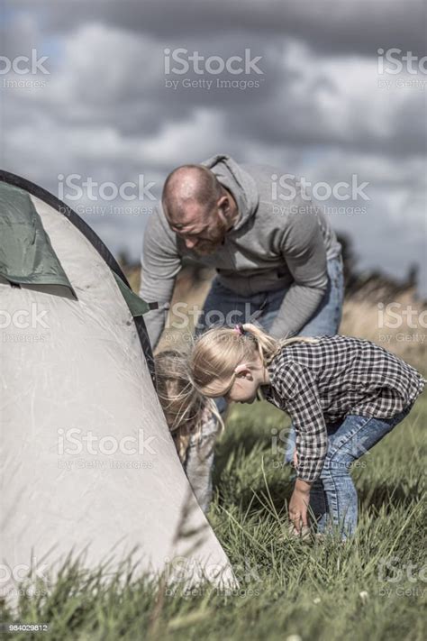 Handsome Redhead Father And Deaf Blonde Daughter Wearing A Hearing Aid Enjoying A Camping