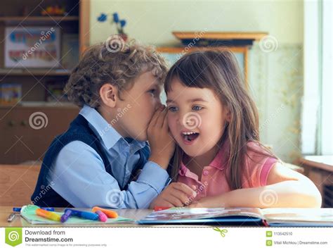 Little Pupils Whispering Secrets During Class At The Elementary School ...