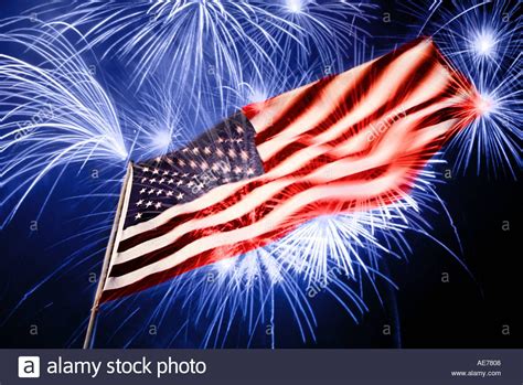 Download This Stock Image American Flag At Night With Fireworks Exploding In The Air Above