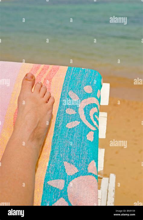 A Womans Leg On A Sunbed At The Beach Stock Photo Alamy
