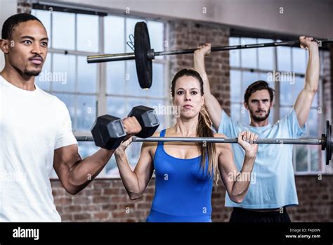 Three Muscular Athletes Lifting Weights Stock Photo Alamy