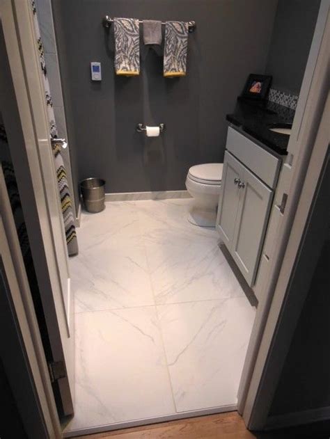 A small bathroom can actually benefit from a large tile. 24x24" tile in small bathroom -- very minimal groutlines ...