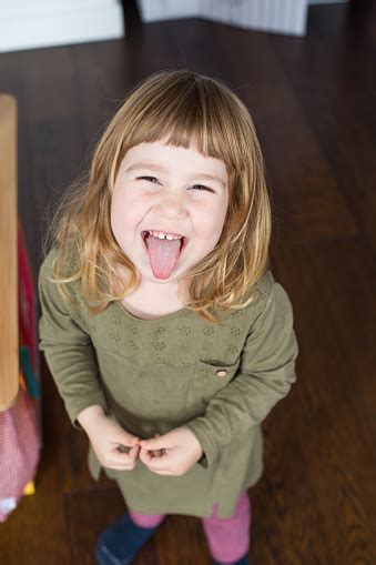 Portrait Of Child Sticking Out Tongue Stock Photo Download Image Now