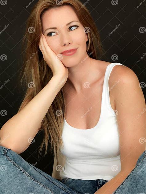 Beautiful Happy Relaxed Young Woman Smiling Sitting In A Chair Stock