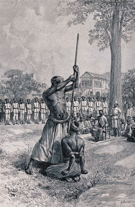 A Ritual Execution Whereby A Victim Kneels On The Ground With His Hands