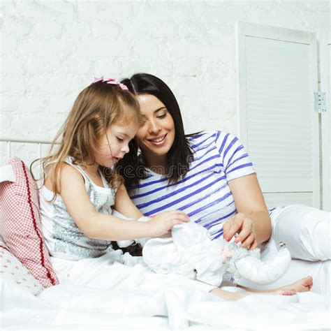Portrait Of Mother And Daughter Laying In Bed And Smiling Stock Image Image Of Indoors Home