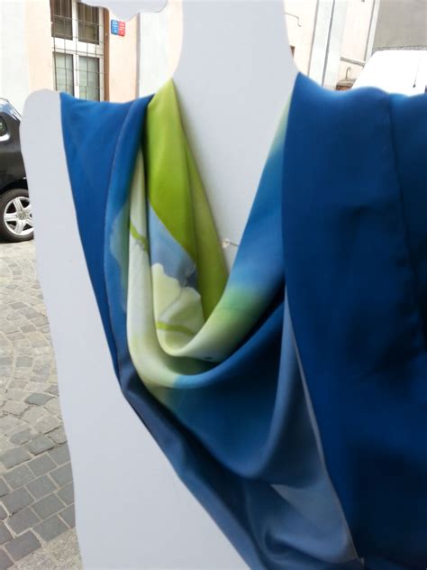 Blue Silk Scarf With Dandelion Displayed On White Silhouette Hand