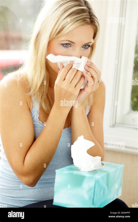 Woman With Tissues Blowing Her Nose Stock Photo Alamy