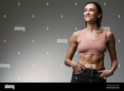 White Woman Wearing Brassiere Smiling And Looking Aside Isolated Over Grey Background Stock