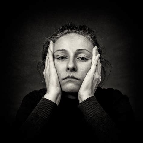 Pensive Woman With Hands Over Her Head In Black And White Stock Image