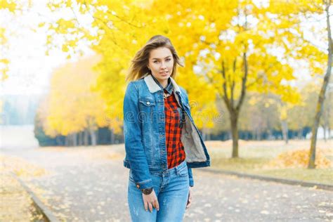 Pretty Girl In Jeans Clothes And A Red Checkered Shirt In Autumn Stock