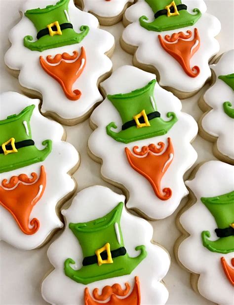 Hand decorated in green and white royal icing colors these magically delicious cookies will bring you and your guests the luck of the irish at your next st. St. Patrick's Day cookies, leprechaun cookies | St patrick ...