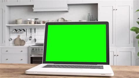 Laptop With Green Screen On Table With Kitchen Backgrounds Stock Footage
