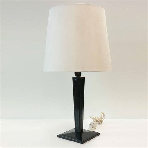 Living rooms require soft lighting to create an inviting atmosphere for your guests. Black Leather Table Lamp | NYLUX