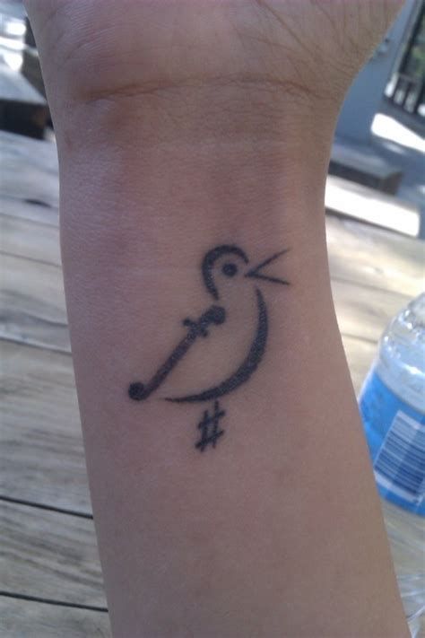 Thicken the end to look like a bass cleft. Bird symbol of music tattoo