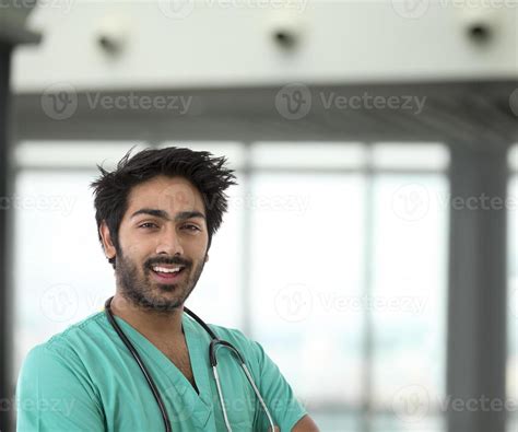 Male Indian Healthcare Worker Wearing A Green Scrubs 867088 Stock