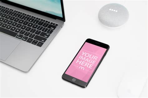iPhone on Desk Next to Macbook Laptop Mockup Generator - Mediamodifier