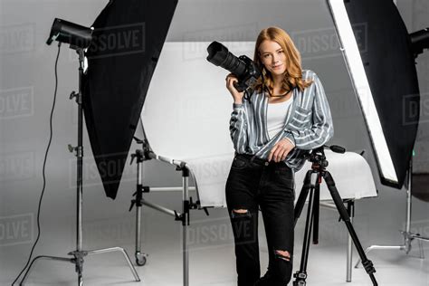 Attractive Young Female Photographer Working In Professional Photo