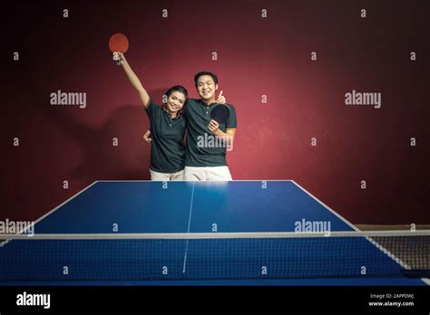 Couples Of Young People Playing Ping Pong With Ping Pong Paddles Having