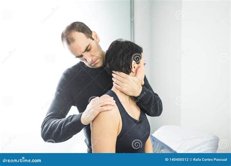 Physical Therapist Massaging A Beautiful Woman Neck Concept Physiotherapy And Osteopathy Stock
