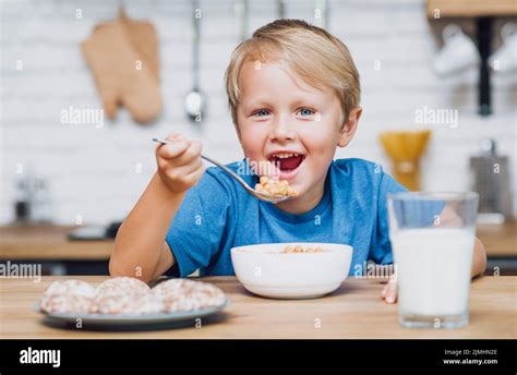 Smiley Kid Eating Cereal Stock Photo Alamy