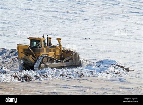 Caterpillar Bulldozer Pushing Snow During Winter Construction Of Inuvik