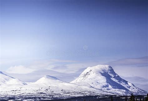 Scandinavian Mountain Range Covered By Ice And Snow Blue Skies Pine