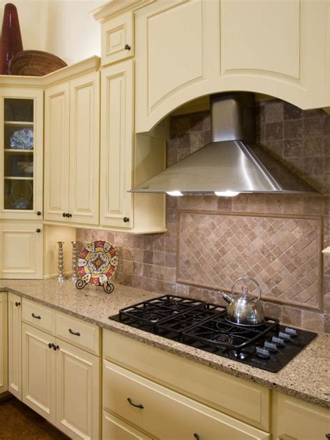 Installers discuss the rules for installing cabinets or a microwave and vent hood above a kitchen range. Photo Page | HGTV