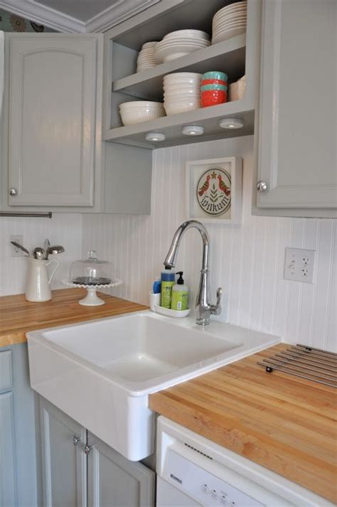 Add as much as needed to fill the entire gap in a manner that the shelf gets stuck between the cabinet and the wall. shelves over sink between cabinets | Beadboard kitchen ...