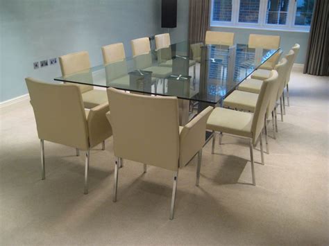 The table can fit 6 chairs around the table. 12-seater-glass-dining-table - Futureglass Blog