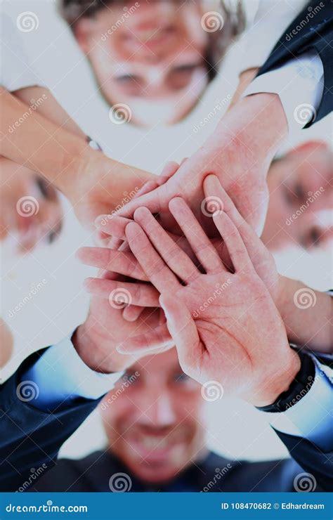 Small Group Of Business People Joining Hands Low Angle View Stock